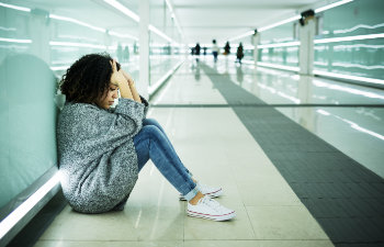 broken woman sitting on the floor